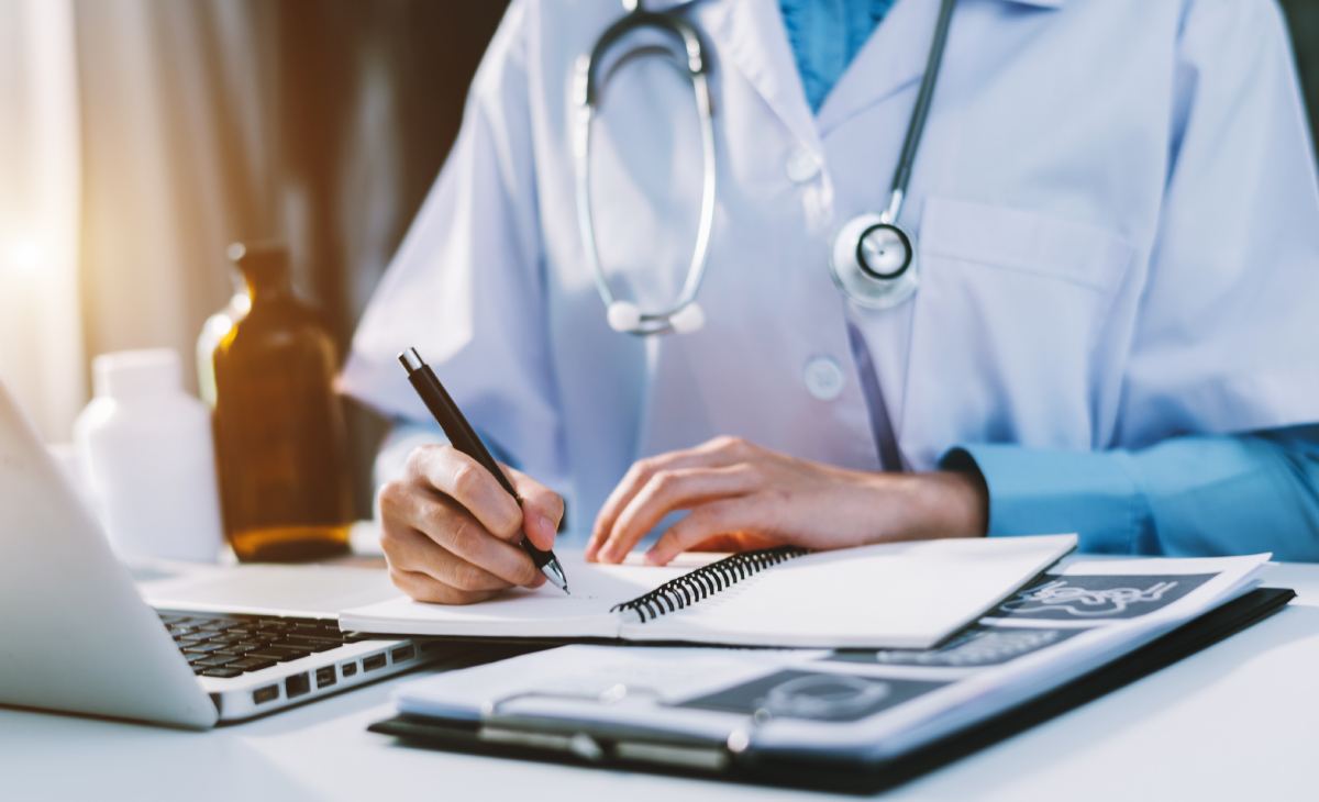 nurse writing on a notebook