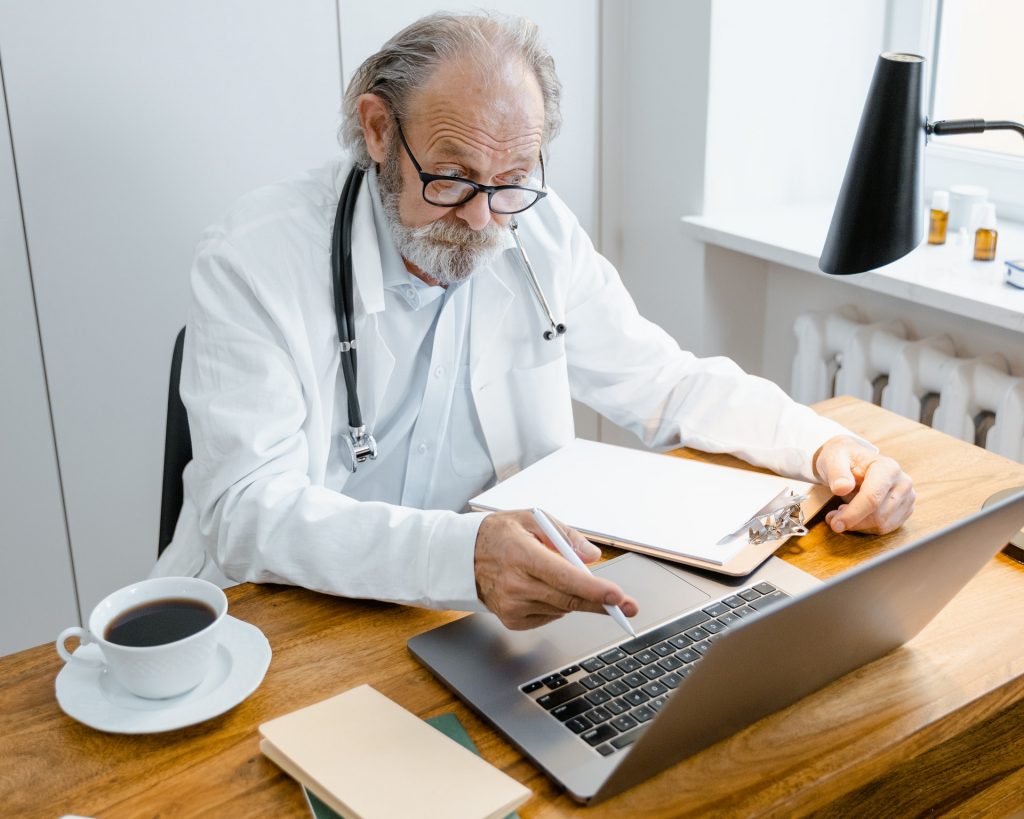 Doctor reading medical transcriptions
