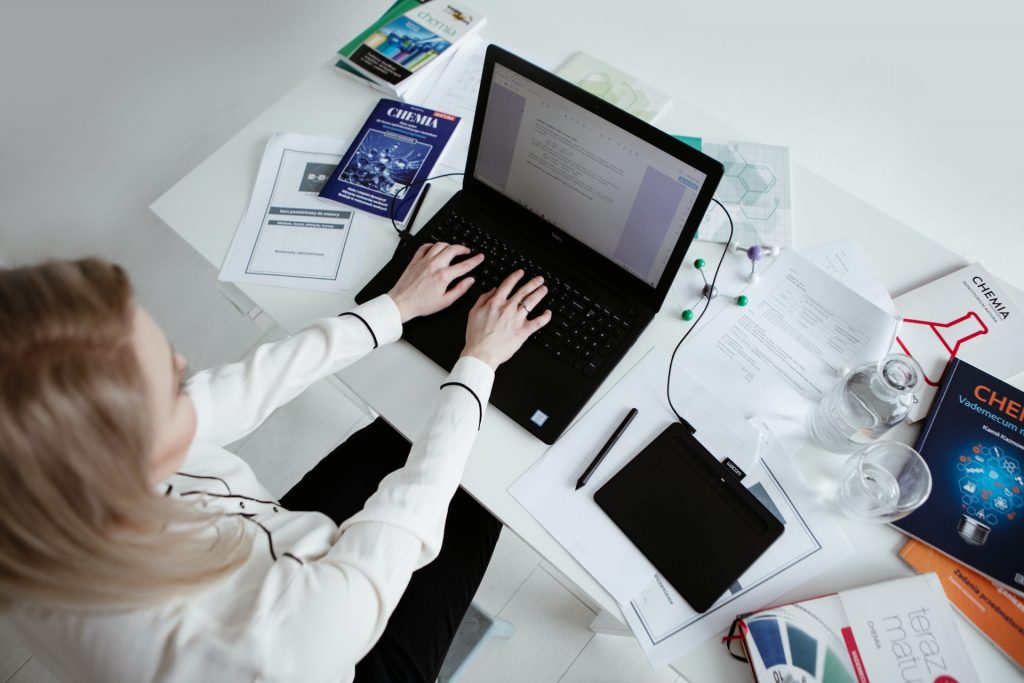 Businessman on laptop managing biotechnology security